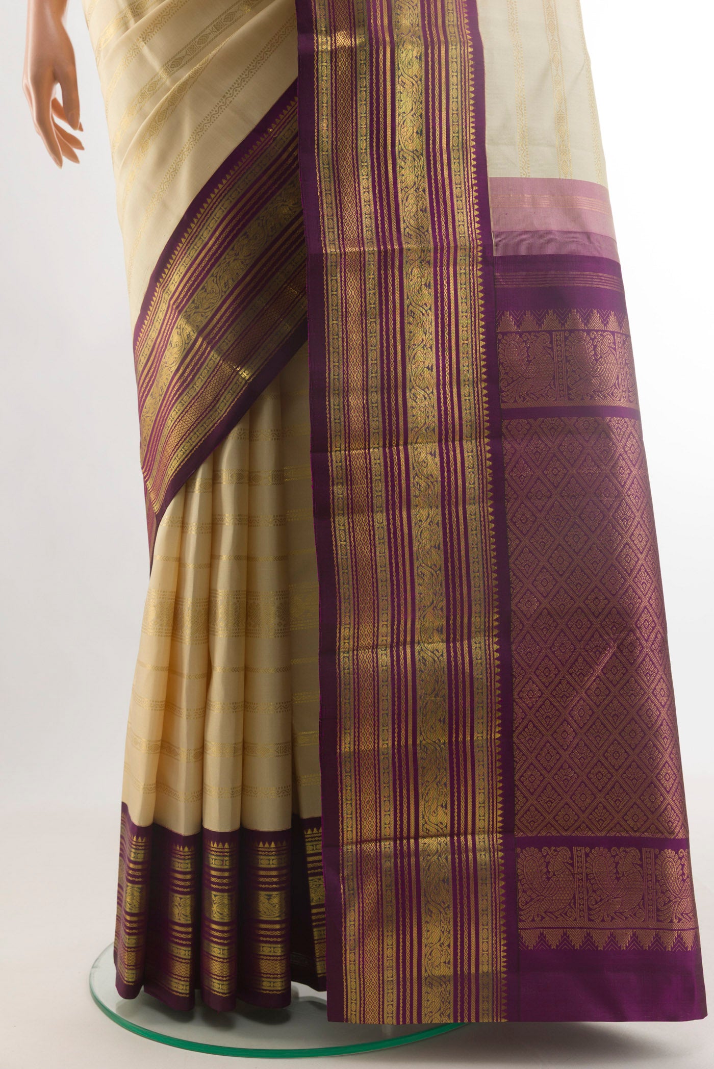 Pleats and pallu of Cream Kanchipuram Silk Saree with Stripes on the body and Ganga Jamuna Border. 
