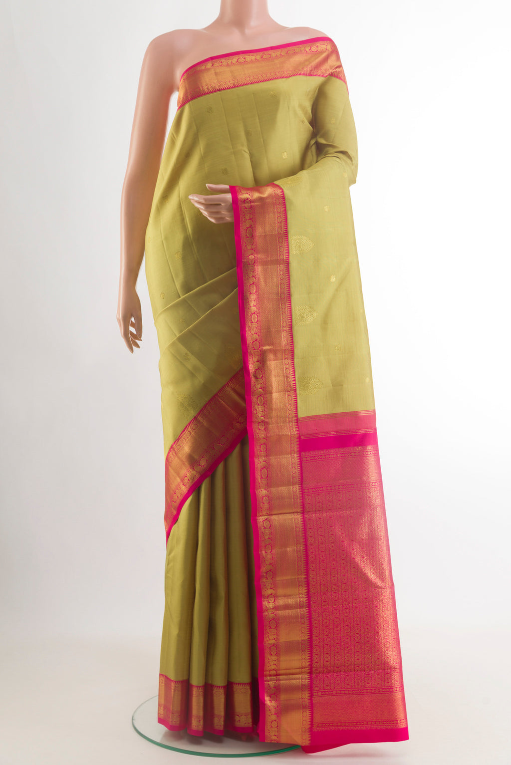 Beige Kanjivaram Silk Saree with Zari Butta on the body and Zari Border.  displayed on a mannequin