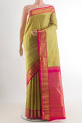 Beige Kanjivaram Silk Saree with Zari Butta on the body and Zari Border.  displayed on a mannequin