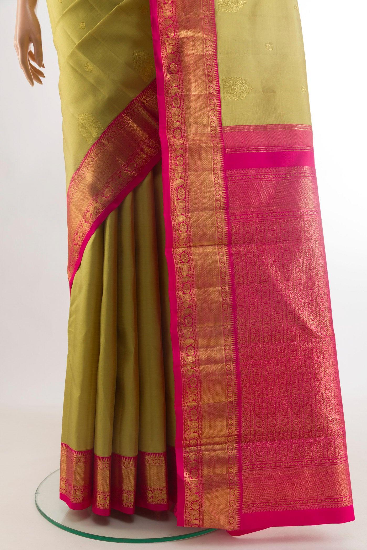 Pleats and pallu of Beige Kanjivaram Silk Saree with Zari Butta on the body and Zari Border. 