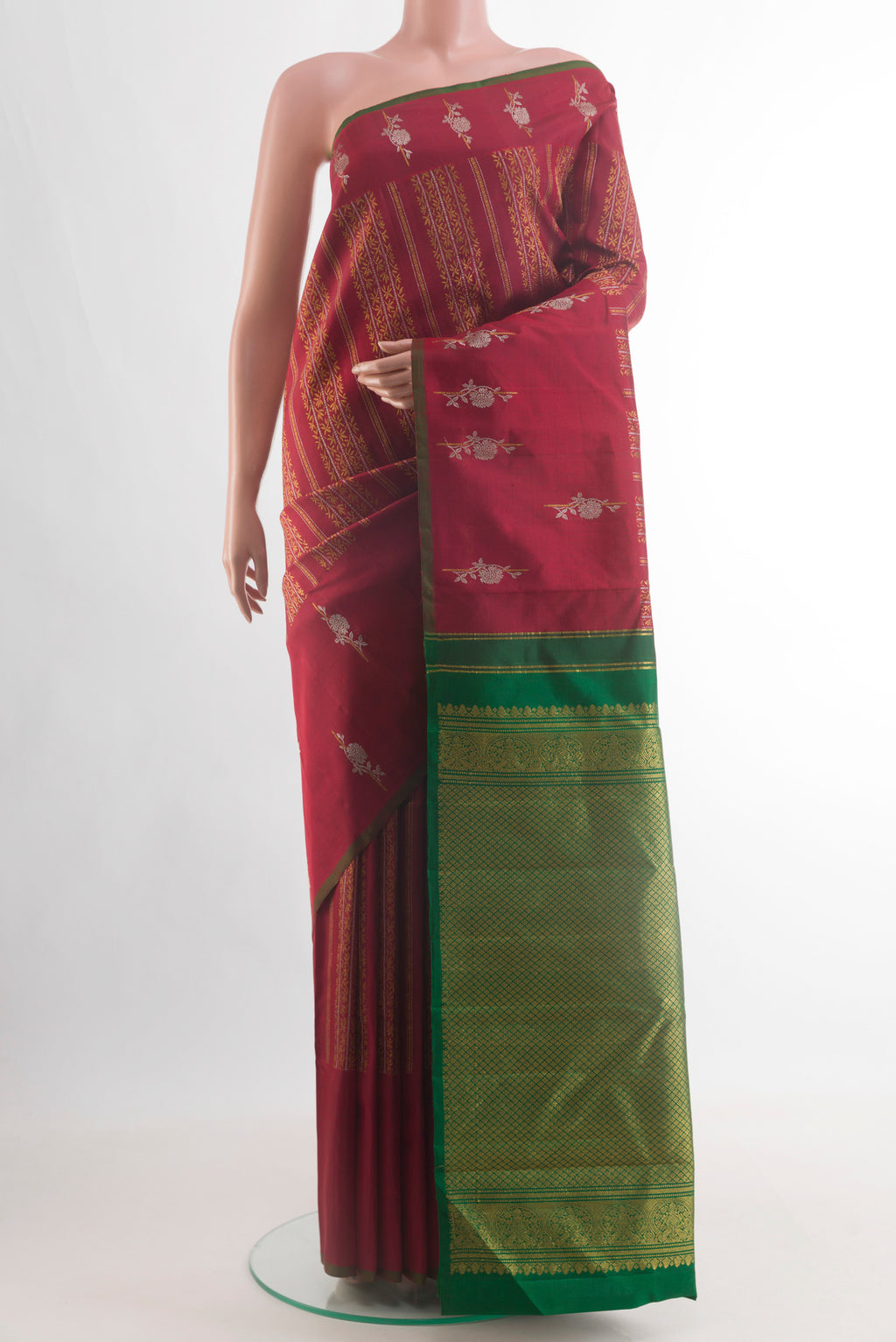 Maroon Kanjivaram Silk Saree with Zari Brocade on the body and Zari Border.  displayed on a mannequin