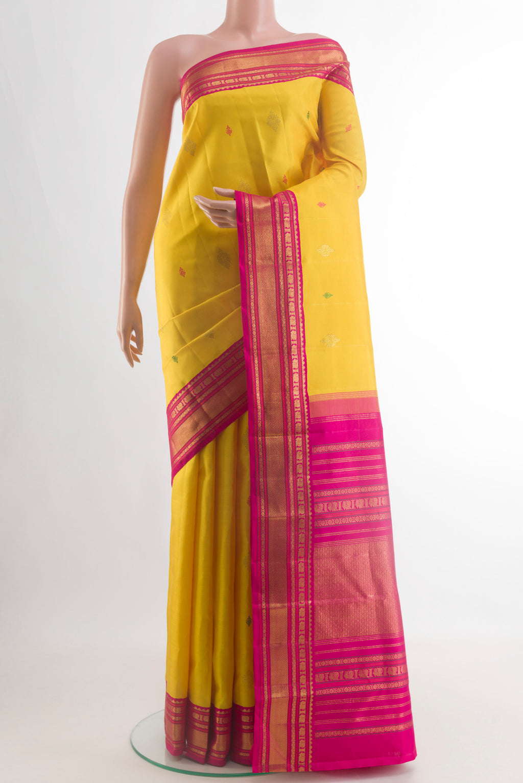 Yellow Kanjivaram Silk Saree with Thread Butta on the body and Zari Border.  displayed on a mannequin