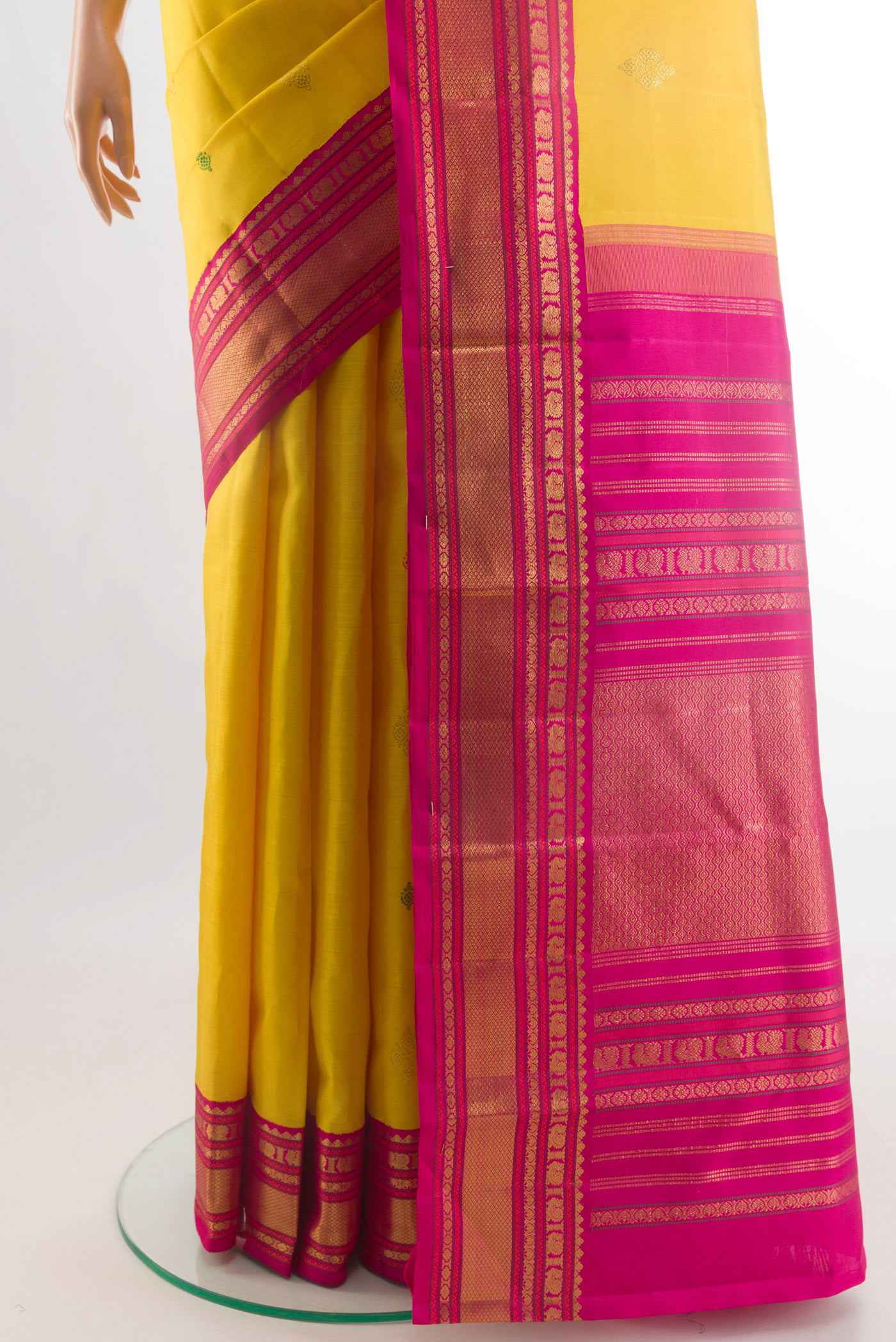 Pleats and pallu of Yellow Kanjivaram Silk Saree with Thread Butta on the body and Zari Border. 