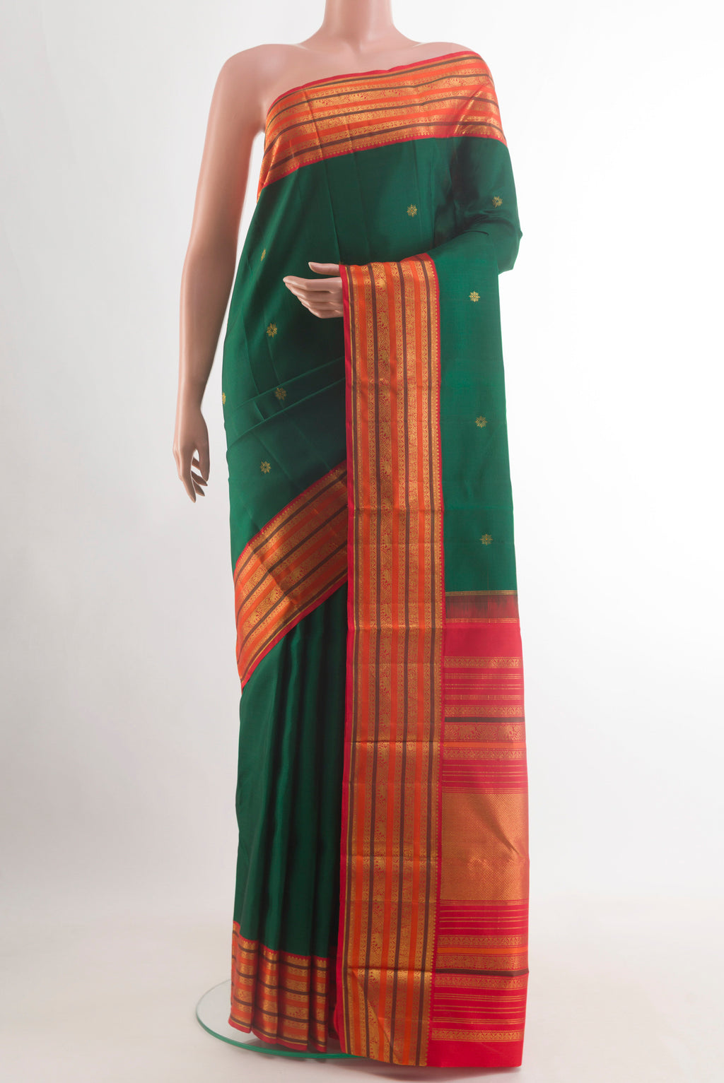 Bottle Green Kanjivaram Silk Saree with Zari Butta on the body and Zari Border.  displayed on a mannequin