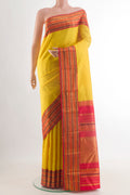 Yellow Kanjivaram Silk Saree with Zari Butta on the body and Zari Border.  displayed on a mannequin