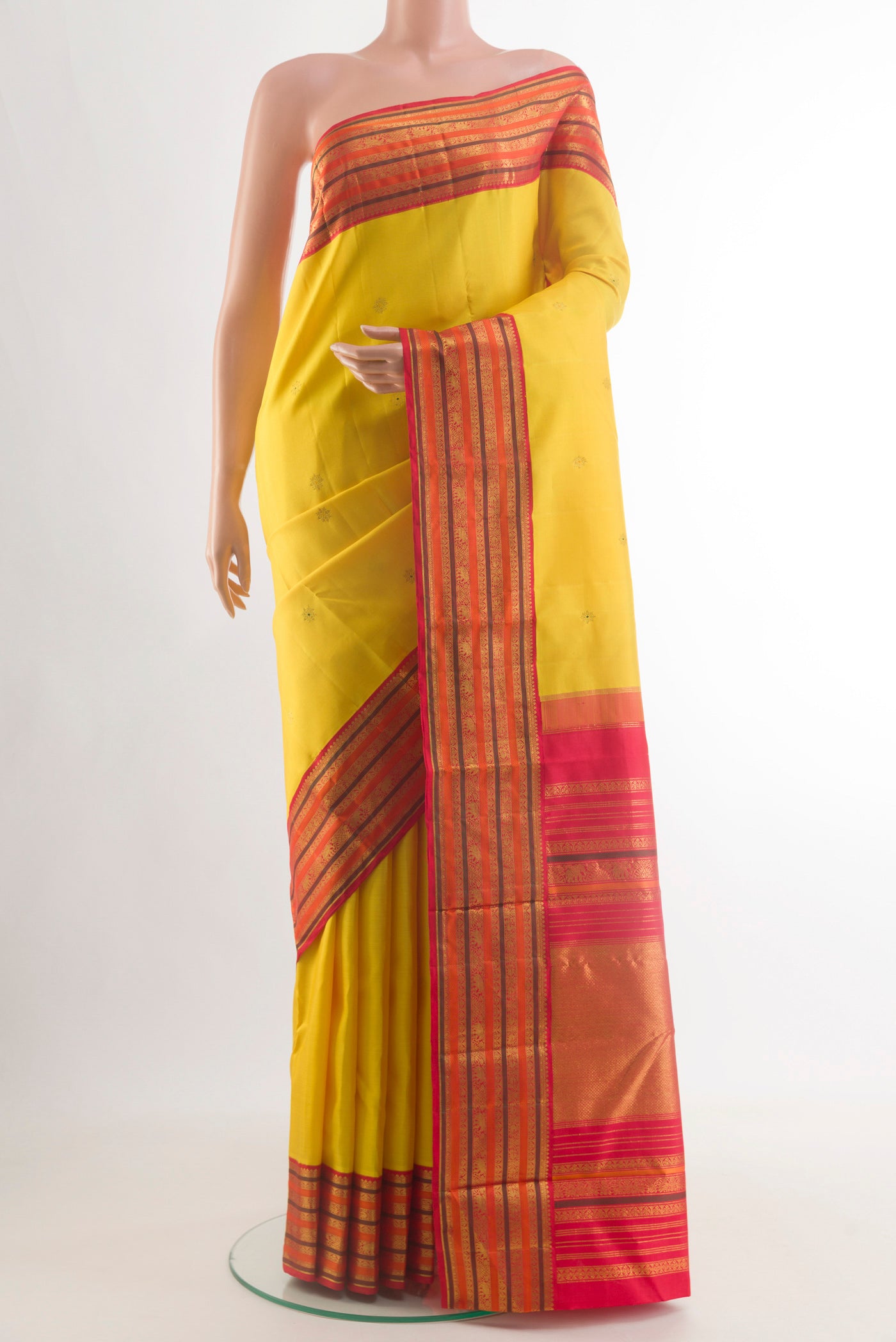 Yellow Kanjivaram Silk Saree with Zari Butta on the body and Zari Border.  displayed on a mannequin