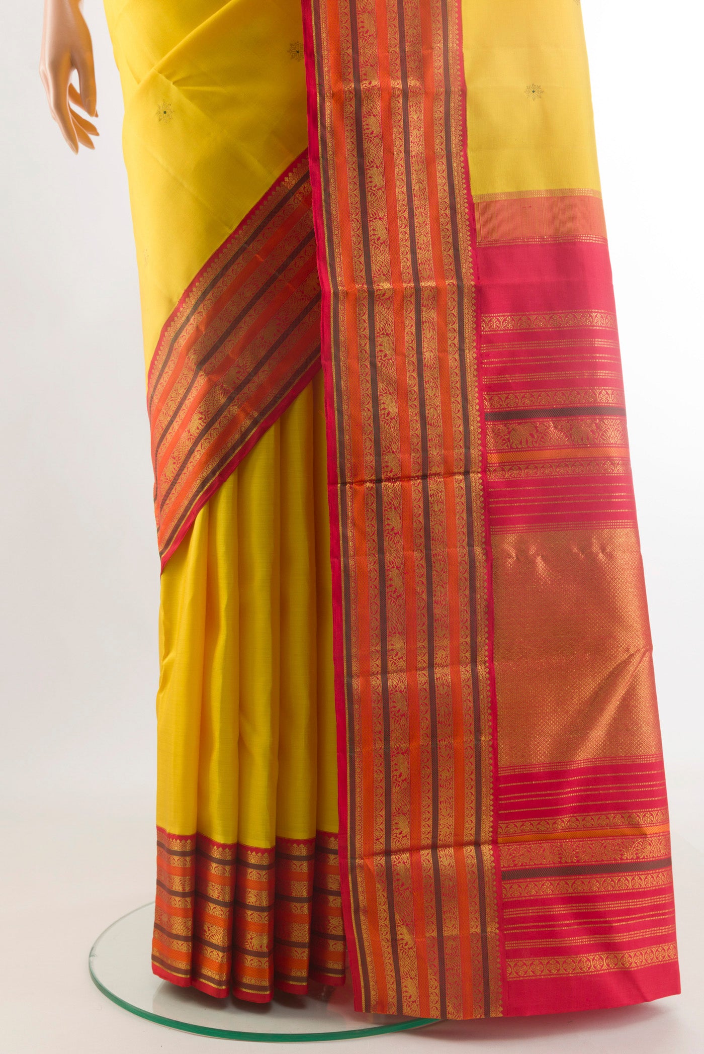 Pleats and pallu of Yellow Kanjivaram Silk Saree with Zari Butta on the body and Zari Border. 