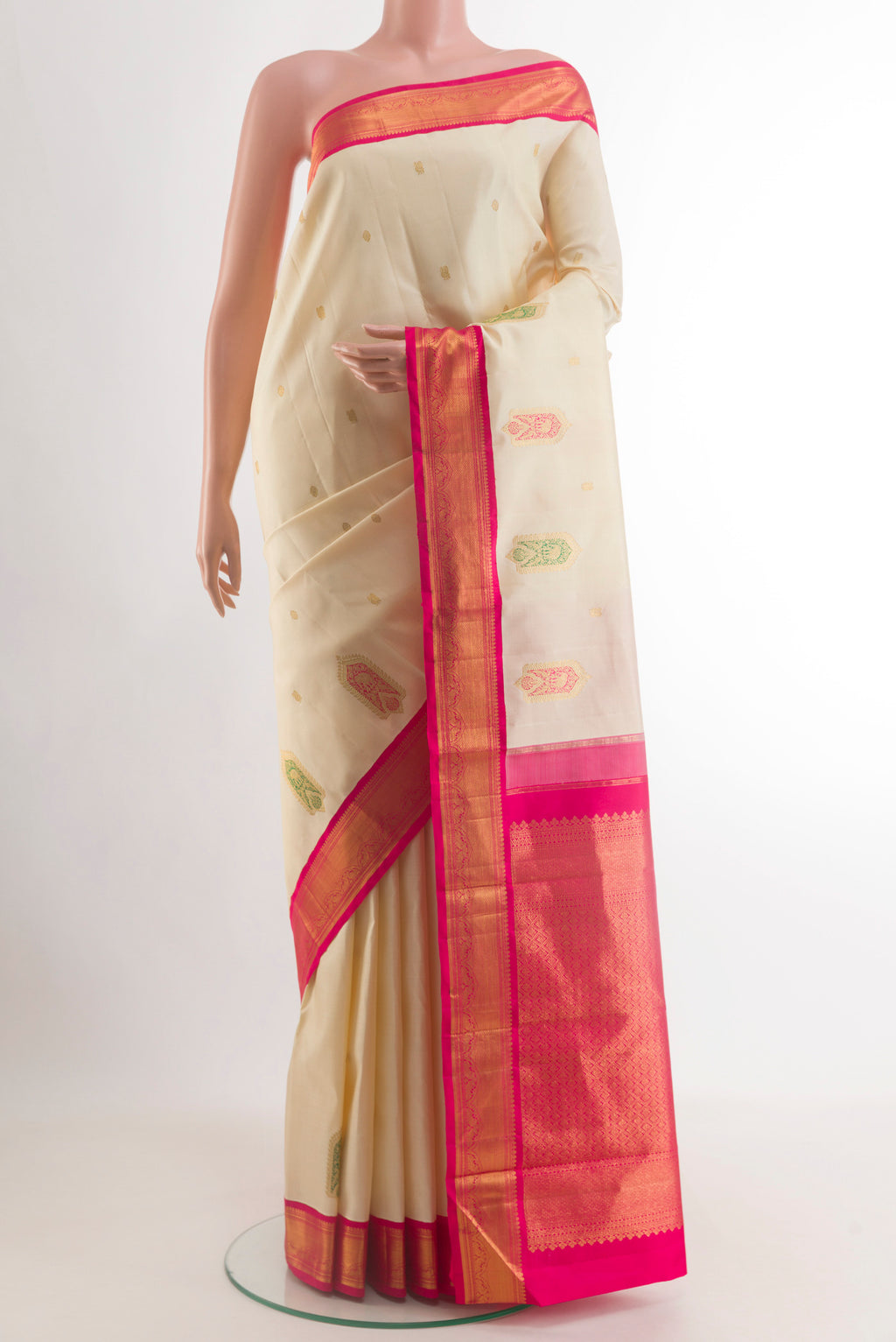 Cream Kanjivaram Silk Saree with Zari Butta on the body and Zari Border.  displayed on a mannequin