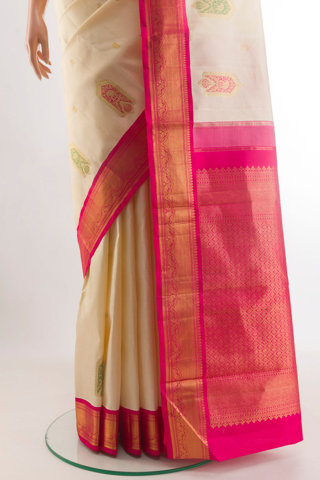 Pleats and pallu of Cream Kanjivaram Silk Saree with Zari Butta on the body and Zari Border. 