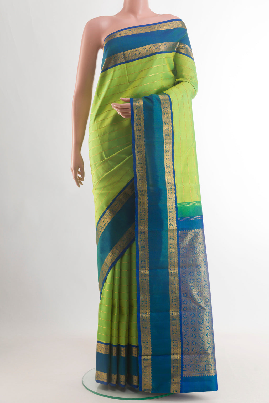 Parrot Green Kanjivaram Silk Saree with Stripes on the body and Zari Border.  displayed on a mannequin