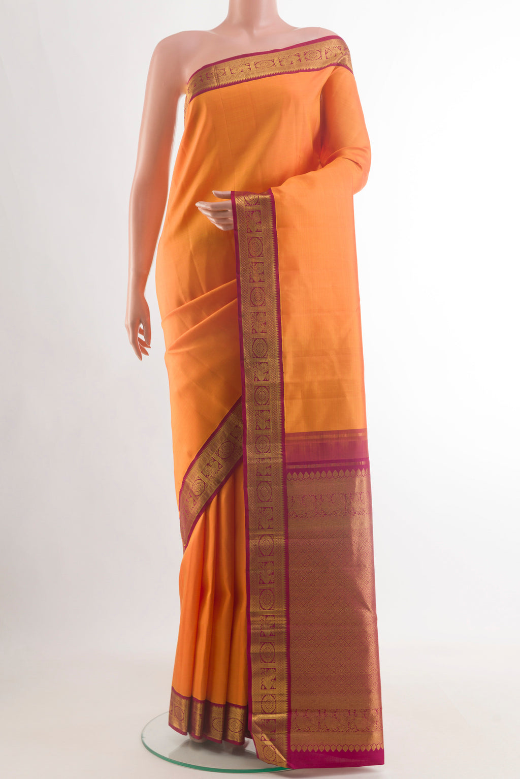 Orange Kanjivaram Silk Saree with Plain Body and Zari Border.  displayed on a mannequin