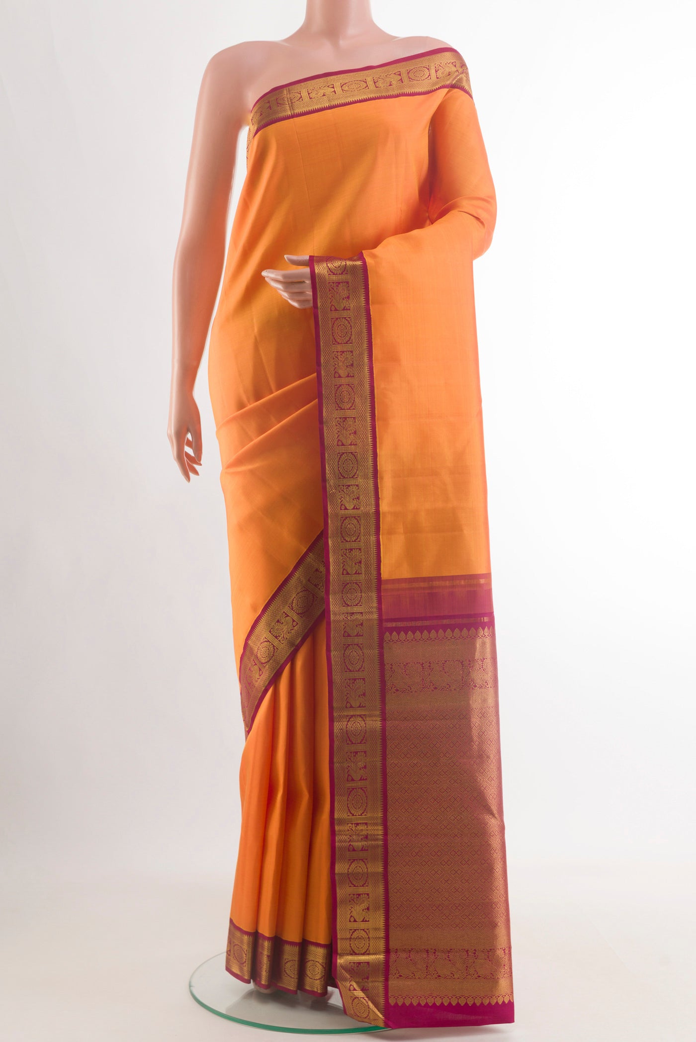 Orange Kanjivaram Silk Saree with Plain Body and Zari Border.  displayed on a mannequin