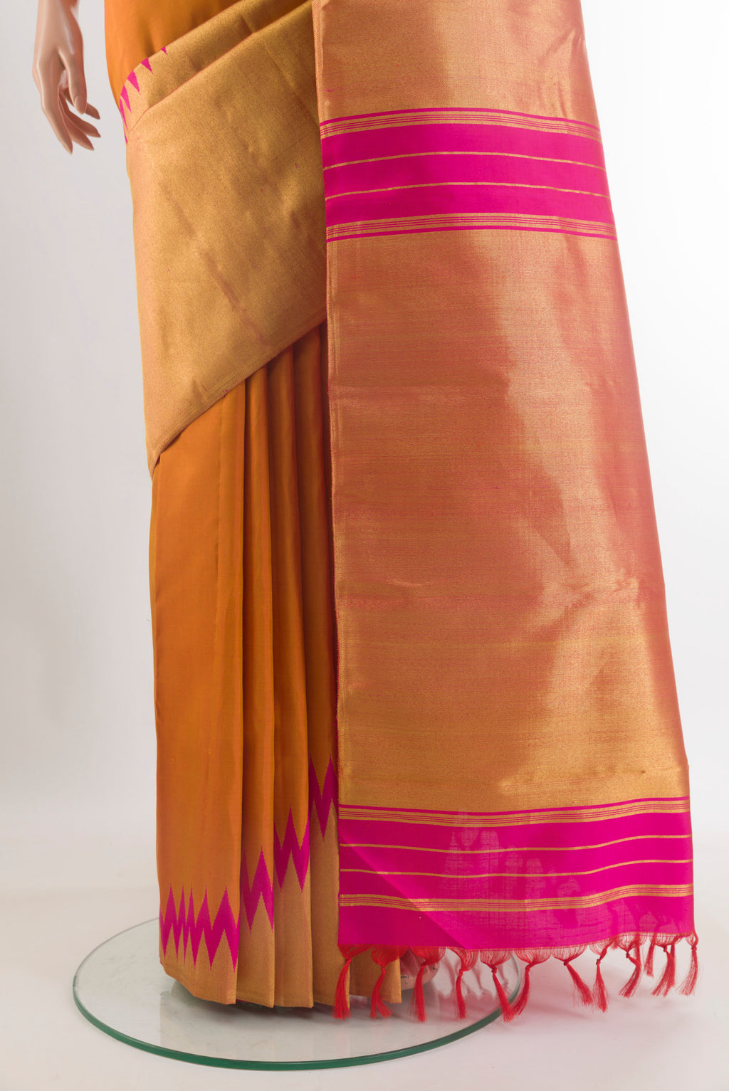 Pleats and pallu of Mustard Kanjivaram Tissue Saree with Plain Body and Temple Border. 