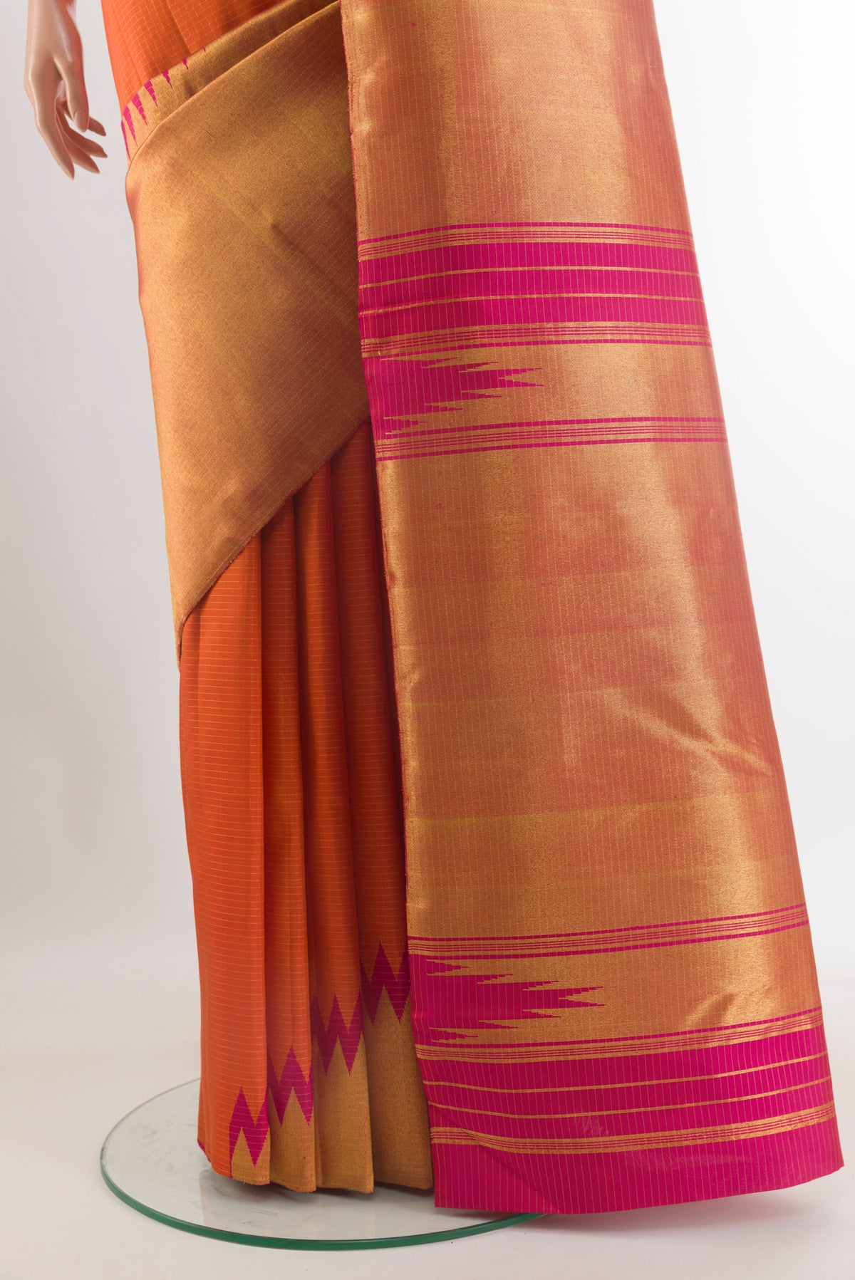 Pleats and pallu of Pure Silk Orange Kanchipuram Saree with Checked design on the body and Temple Border. 