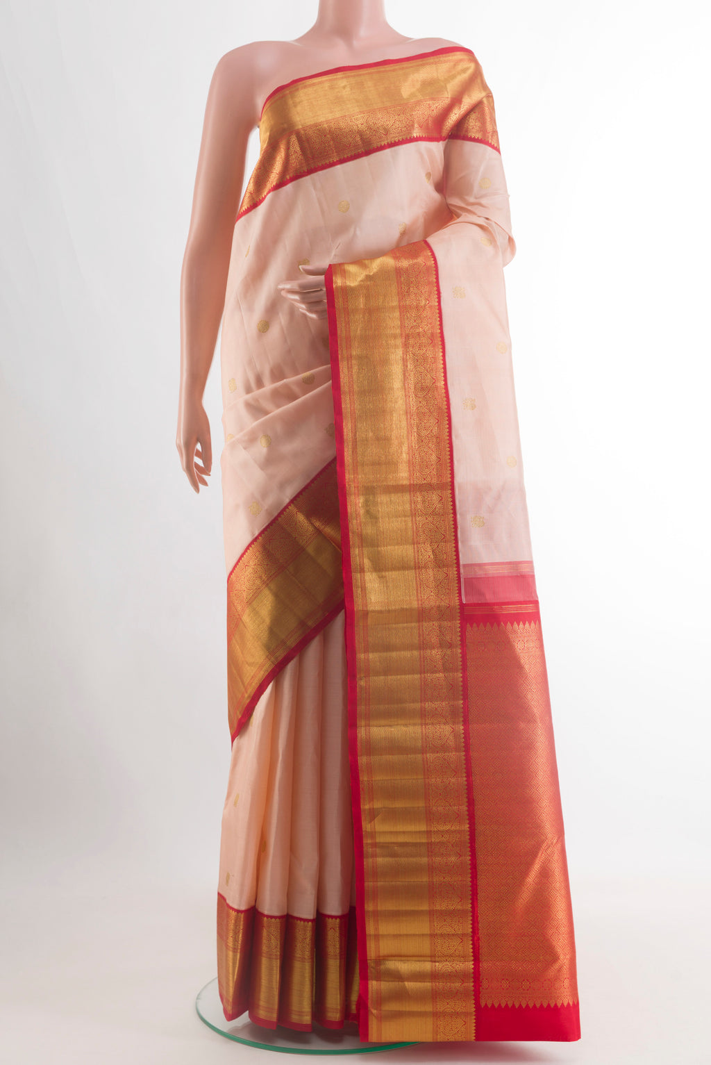 Rose pink Kanchipuram Silk Saree with Zari Butta on the body and Zari Border.  displayed on a mannequin