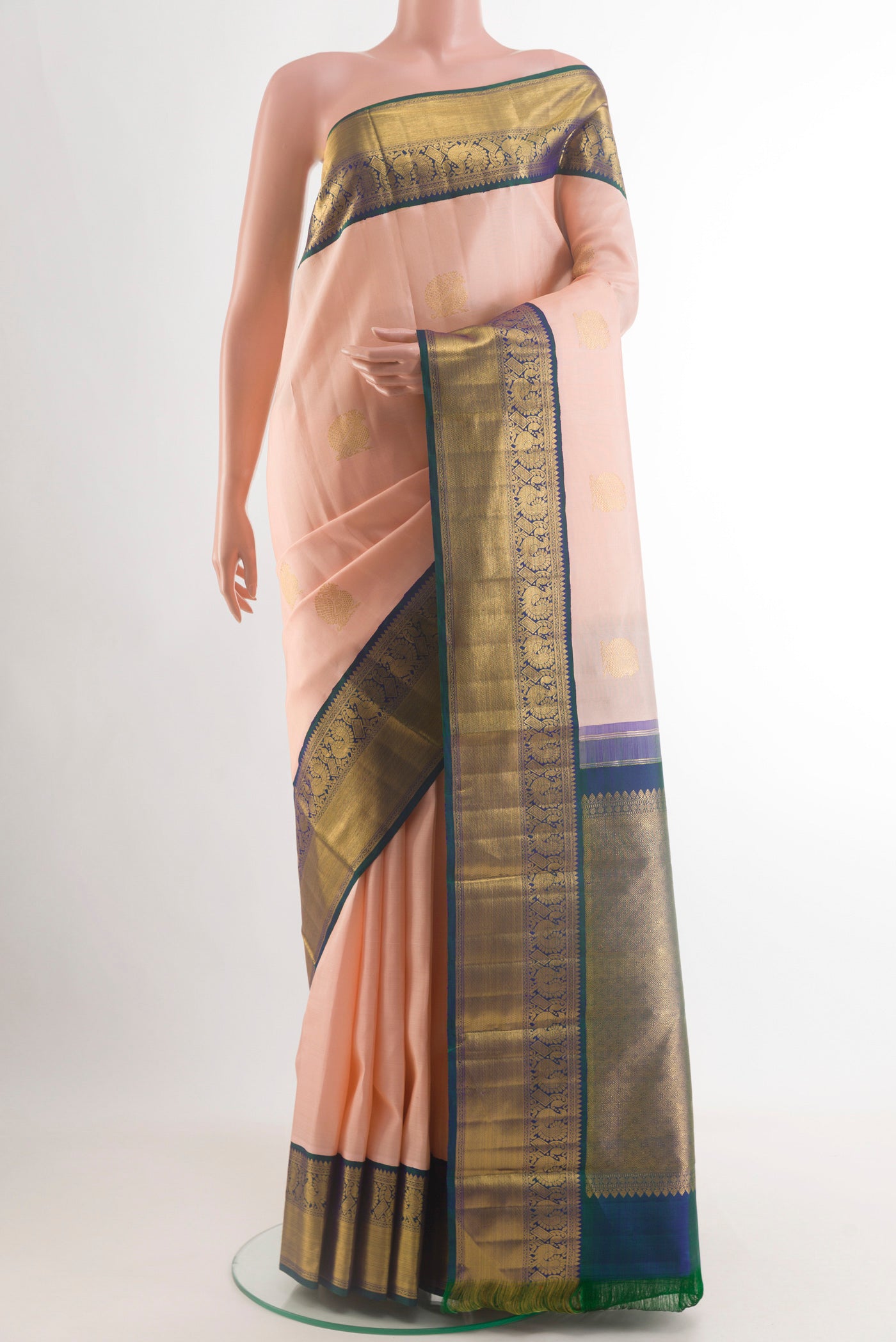 Rose pink Kanchipuram Silk Saree with Zari Butta on the body and Zari Border.  displayed on a mannequin