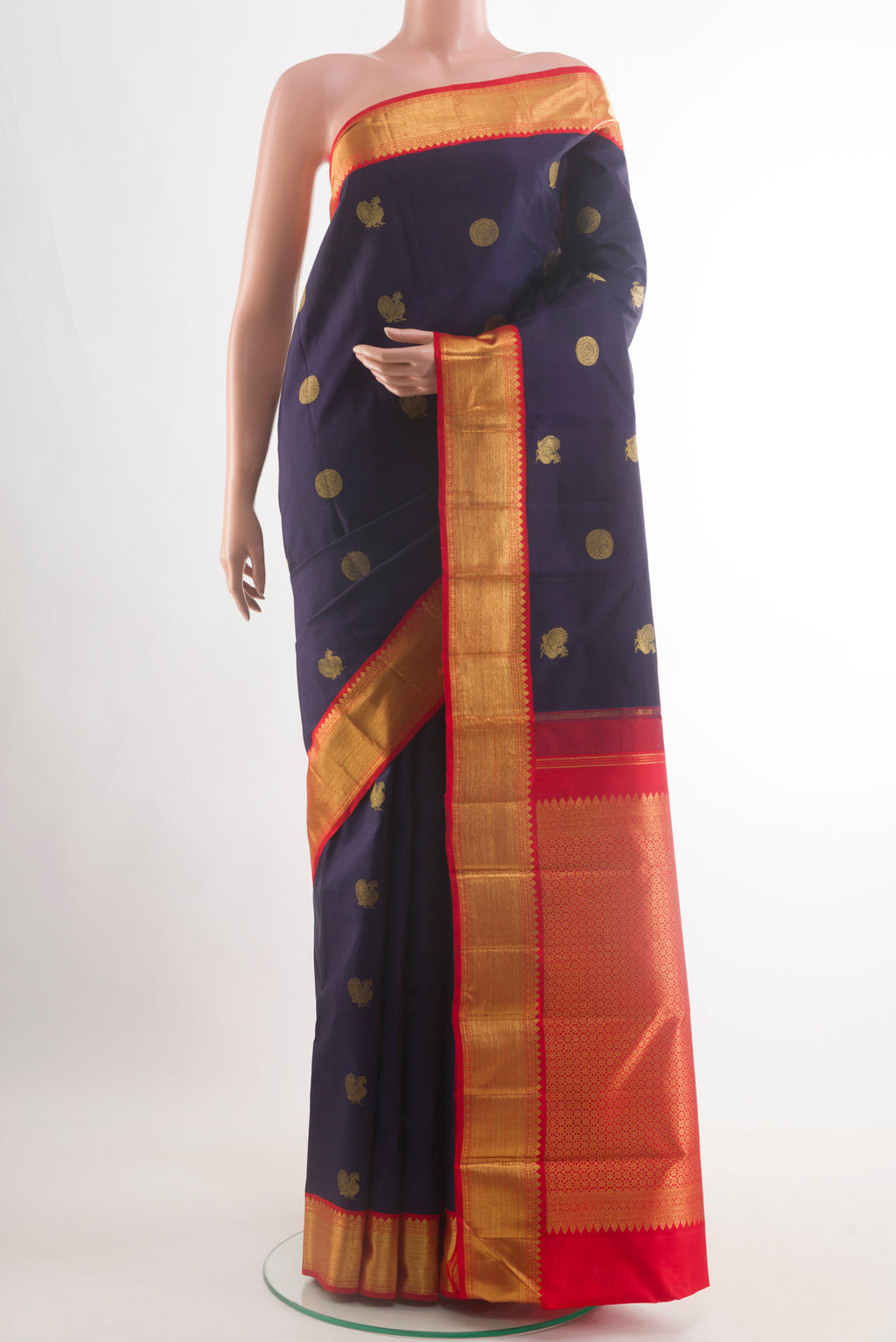 Navy Blue Kanchipuram Silk Saree with Zari Butta on the body and Zari Border.  displayed on a mannequin