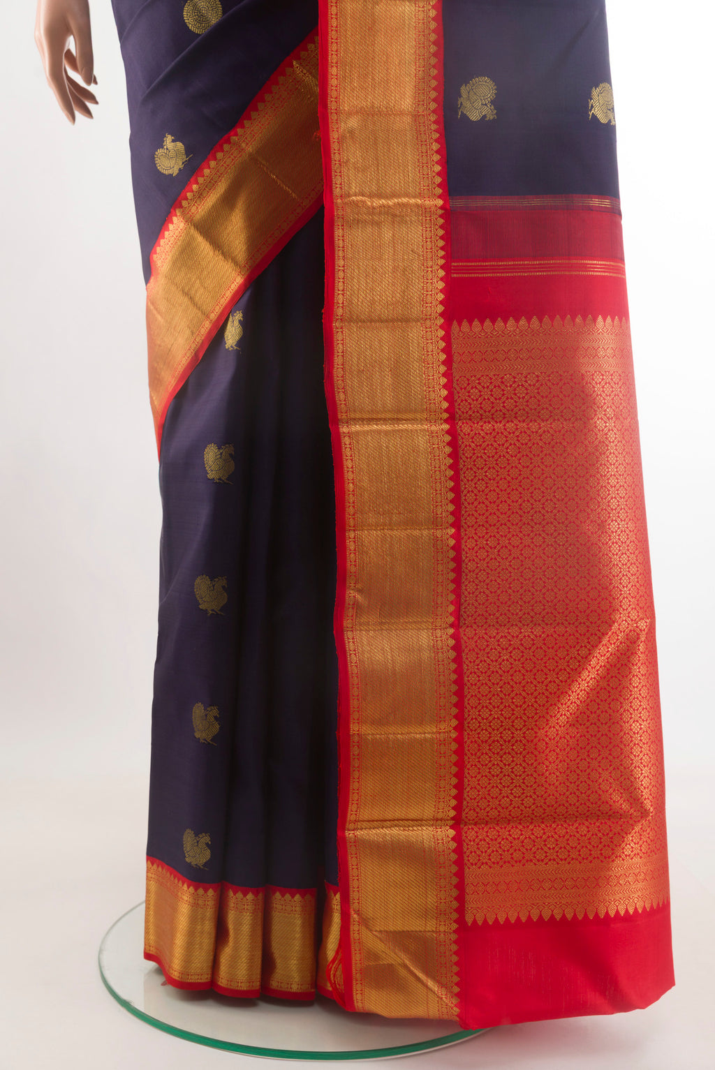 Pleats and pallu of Navy Blue Kanchipuram Silk Saree with Zari Butta on the body and Zari Border. 