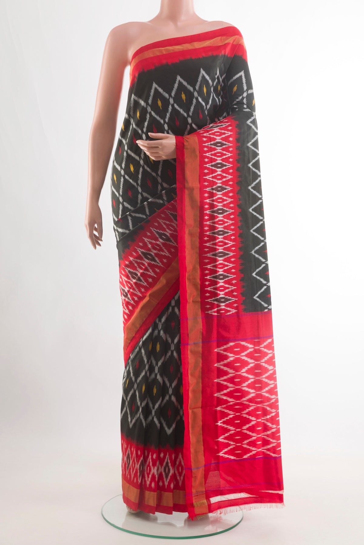 Black Pochampally Silk Saree with Pure Ikat on the body and Ikat Border.  displayed on a mannequin
