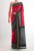 Red Pochampally Silk Saree with Pure Ikat on the body and Ikat Border.  displayed on a mannequin