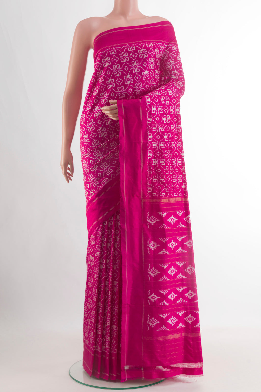 Rani Pink Pochampally Silk Saree with Ikat design on the body and Plain Border.  displayed on a mannequin