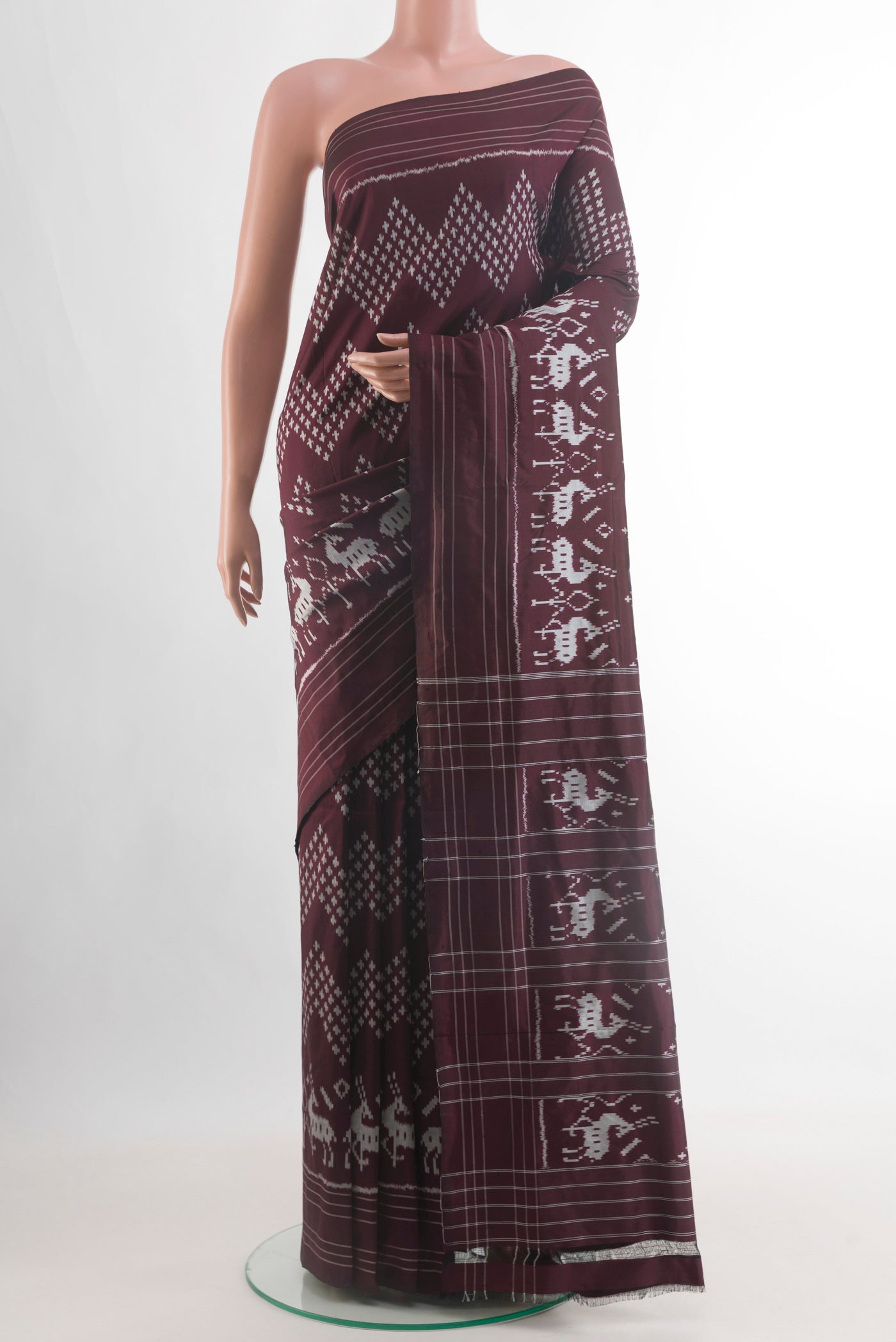 Brown Pochampally Silk Saree with Ikat design on the body and Plain Border.  displayed on a mannequin