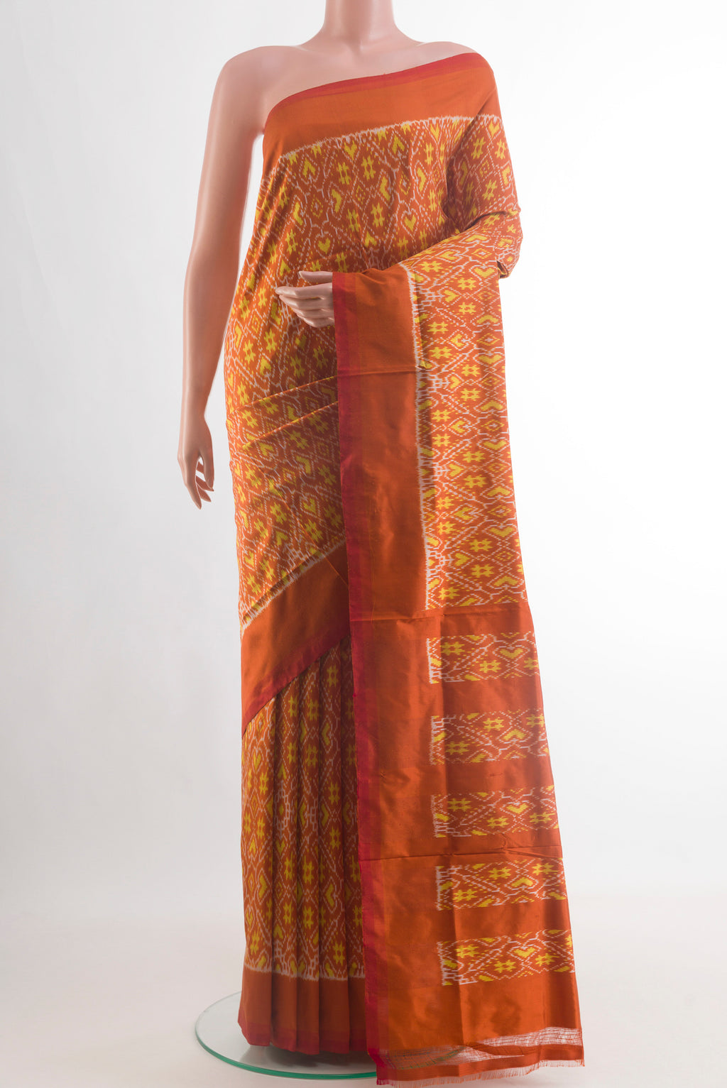 Rust Pochampally Silk Saree with Ikat design on the body and Plain Border.  displayed on a mannequin