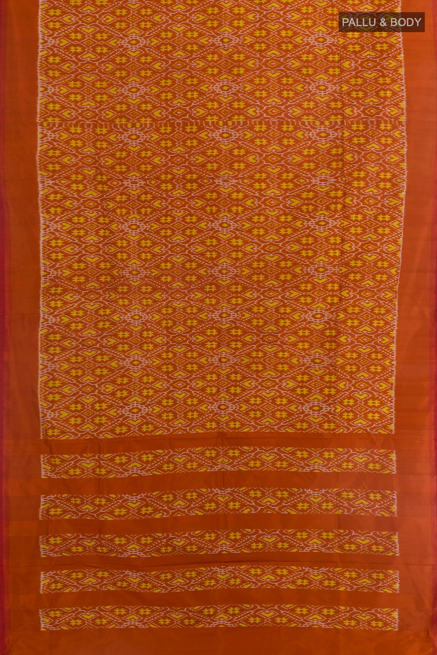 Flat view of Rust Pochampally Silk Saree with Ikat design on the body and Plain Border. 