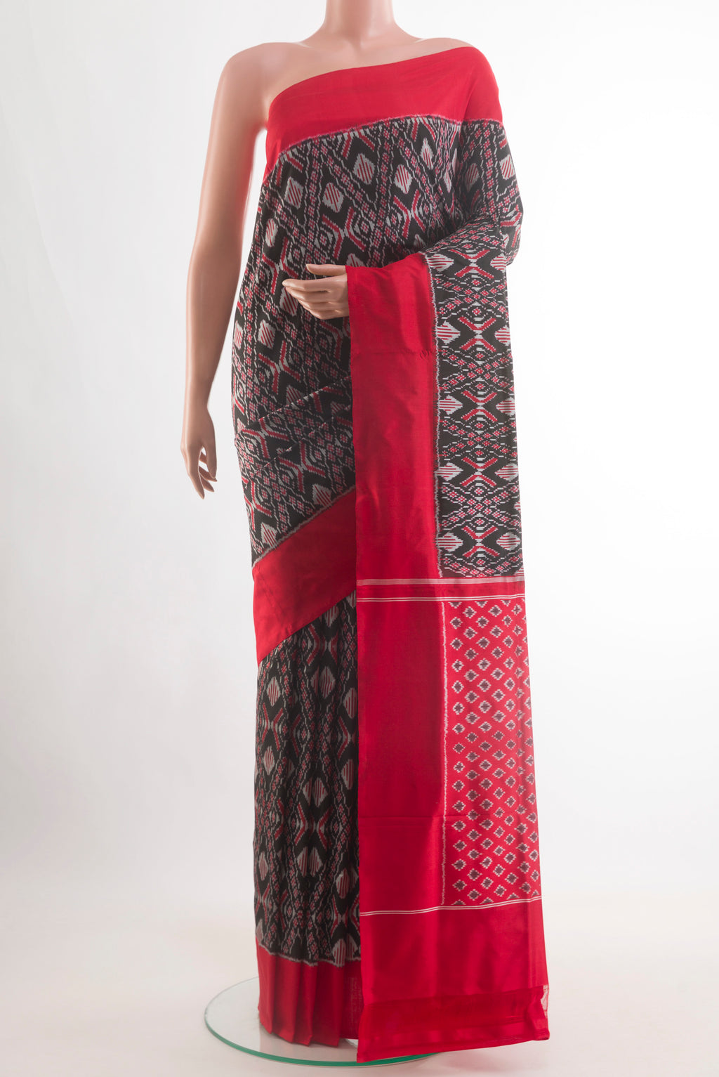 Black Pochampally Silk Saree with Pure Ikat on the body and Plain Border.  displayed on a mannequin