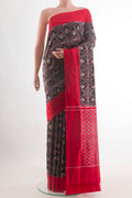 Black Pochampally Silk Saree with Pure Ikat on the body and Plain Border.  displayed on a mannequin