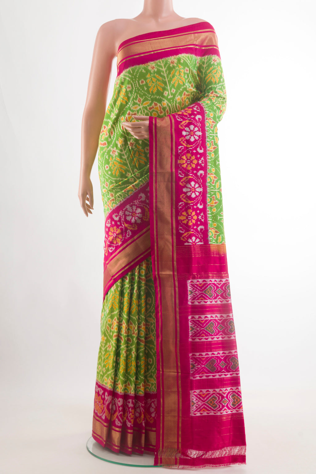 Green Pochampally Silk Saree with Pure Ikat on the body and Zari Border.  displayed on a mannequin