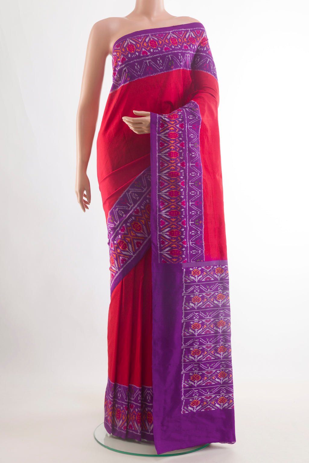Red Pochampally Silk Saree with Plain Body and Ikat Border.  displayed on a mannequin