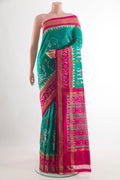 Sea Green Pochampally Silk Saree with Pure Ikat on the body and Zari Border.  displayed on a mannequin