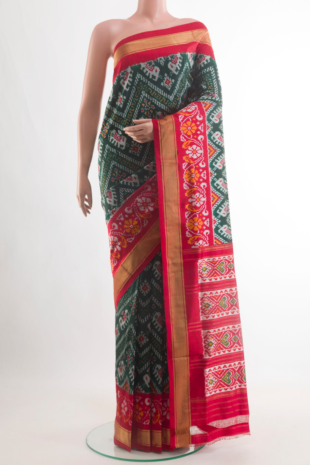 Bottle Green Pochampally Silk Saree with Pure Ikat on the body and Zari Border.  displayed on a mannequin