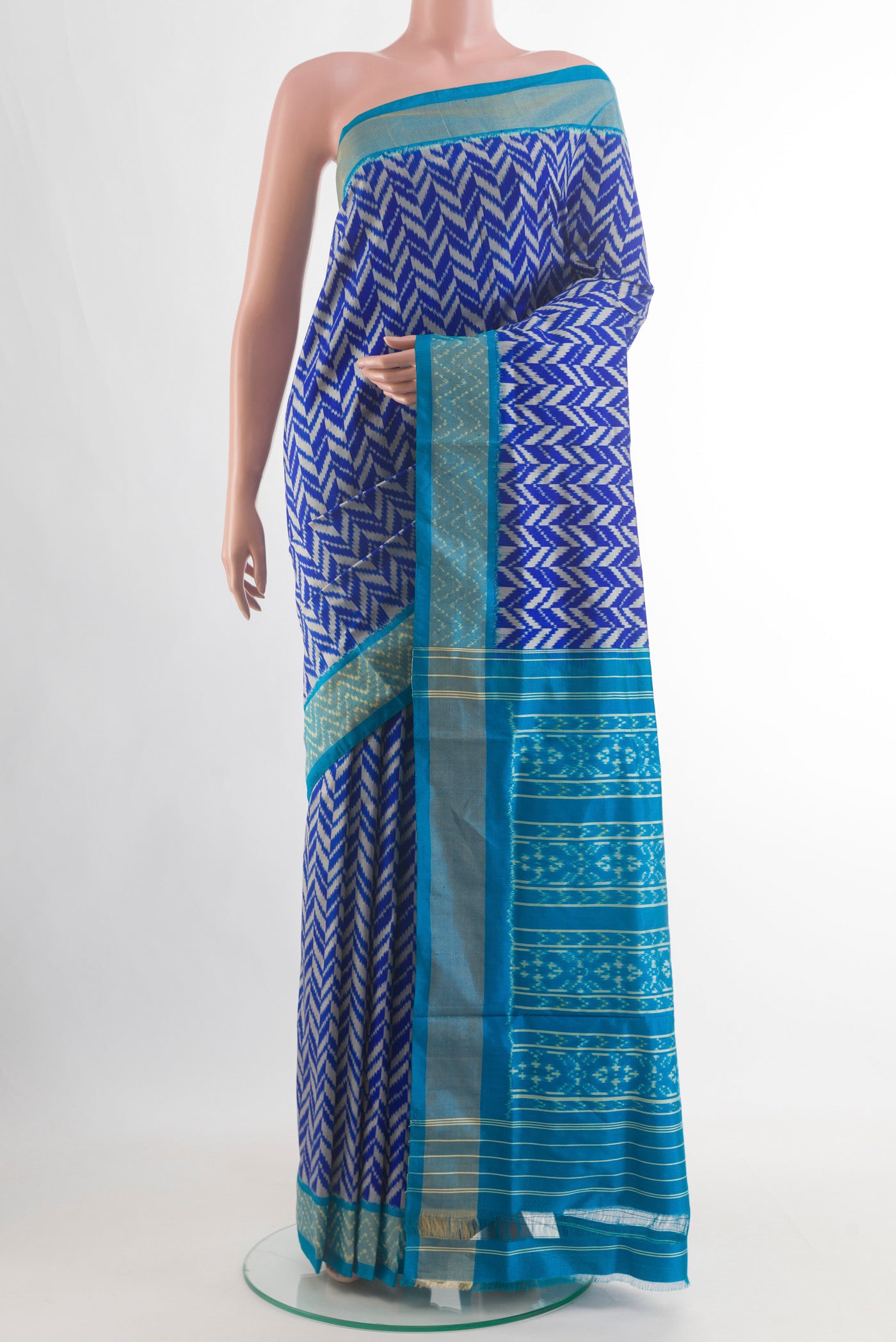 Royal Blue Pochampally Silk Saree with Pure Ikat on the body and Zari Border.  displayed on a mannequin