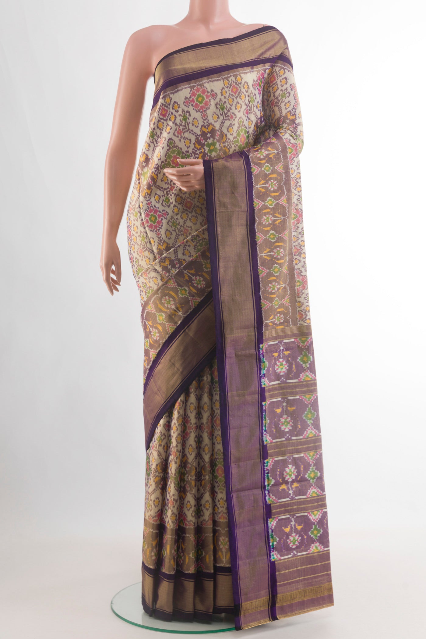 Off White Pochampally Silk Saree with Ikat design on the body and Zari Border.  displayed on a mannequin