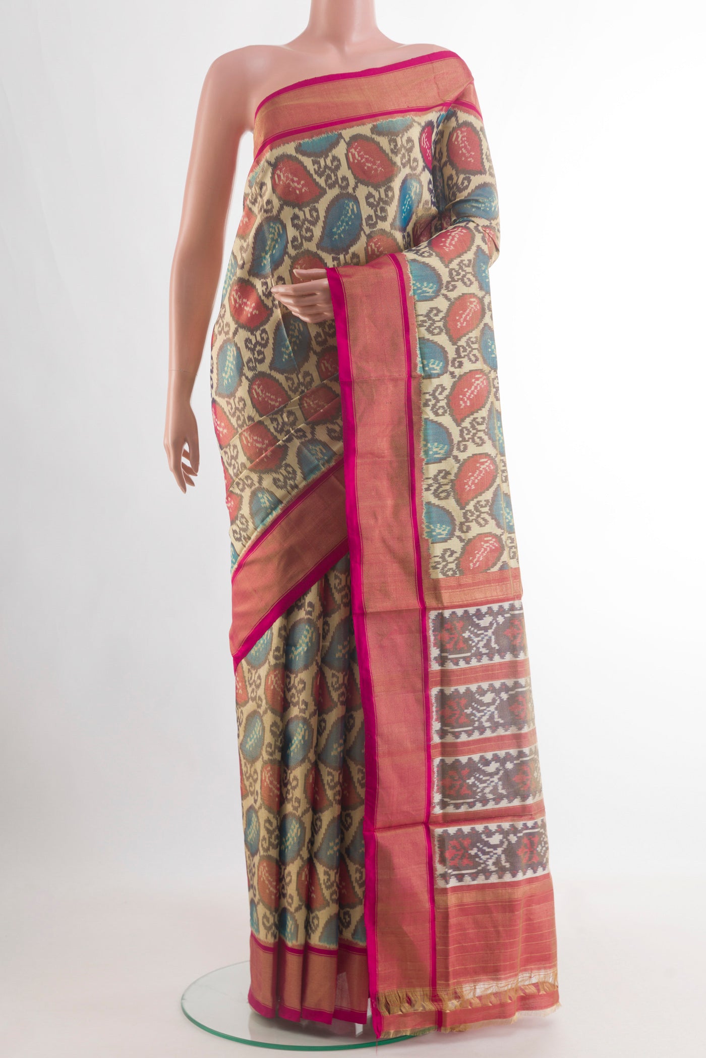 Golden Pochampally Silk Saree with Ikat design on the body and Plain Border.  displayed on a mannequin