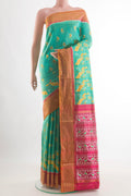 Sea Green Pochampally Silk Saree with Pure Ikat on the body and Zari Border.  displayed on a mannequin