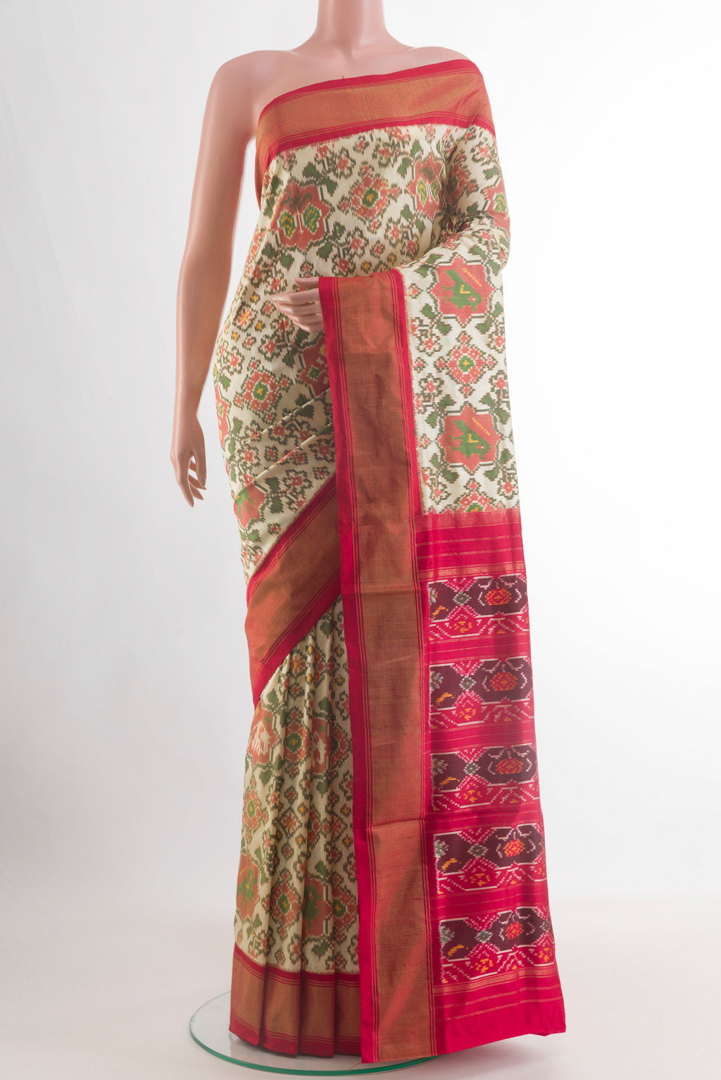 Off White Pochampally Silk Saree with Ikat design on the body and Zari Border.  displayed on a mannequin