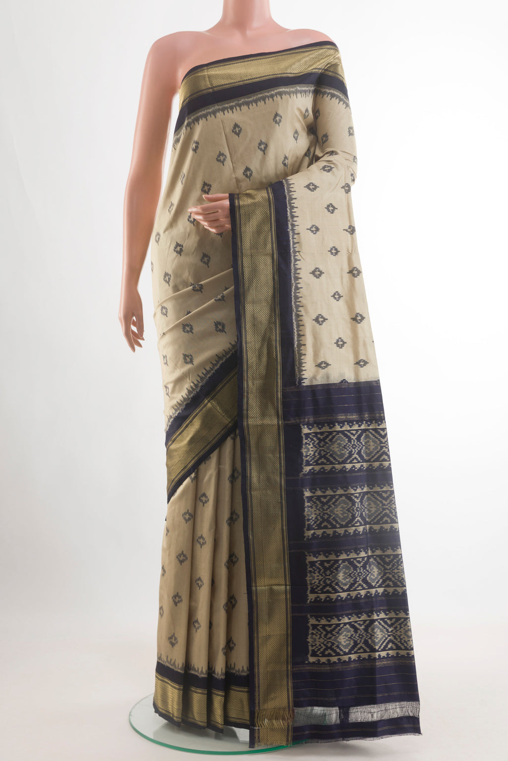 Beige Pochampally Silk Saree with Pure Ikat on the body and Zari Border.  displayed on a mannequin