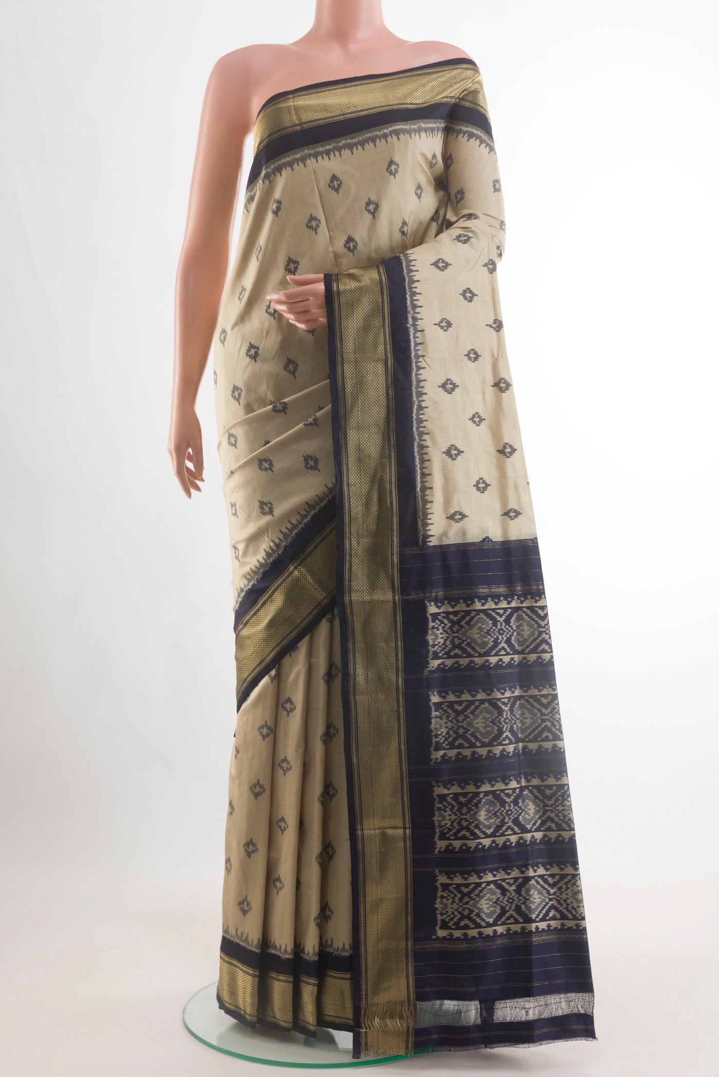 Beige Pochampally Silk Saree with Pure Ikat on the body and Zari Border.  displayed on a mannequin