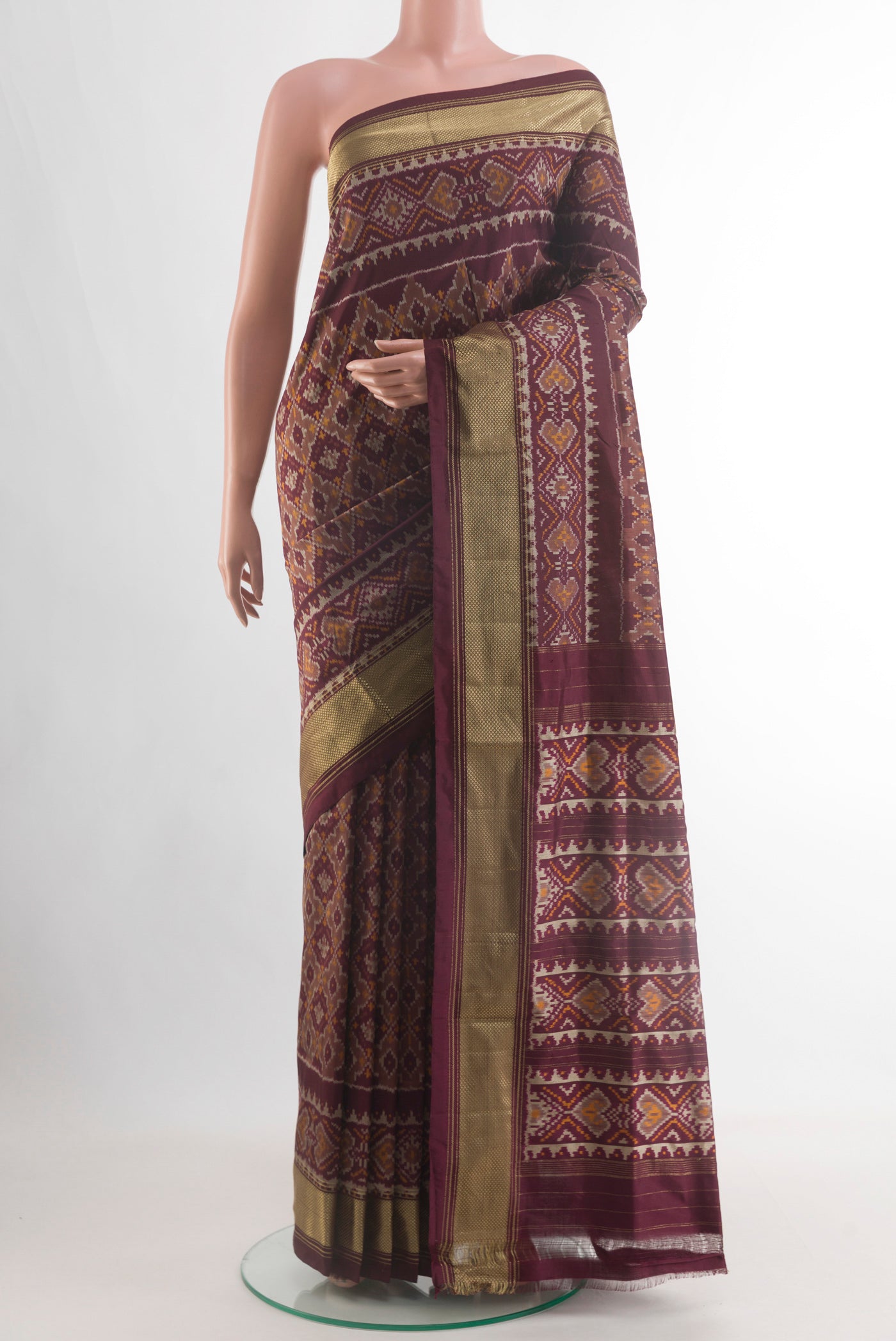 Coffee Brown Pochampally Silk Saree with Ikat design on the body and Zari Border.  displayed on a mannequin