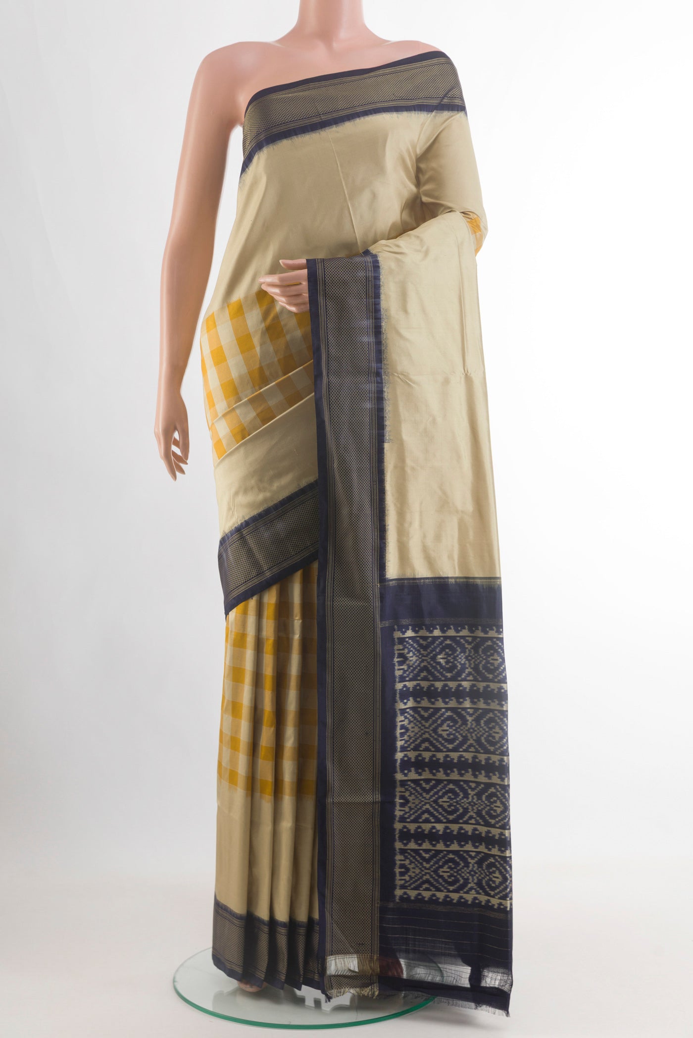 Beige Pochampally Silk Saree with Checked design on the body and Zari Border.  displayed on a mannequin