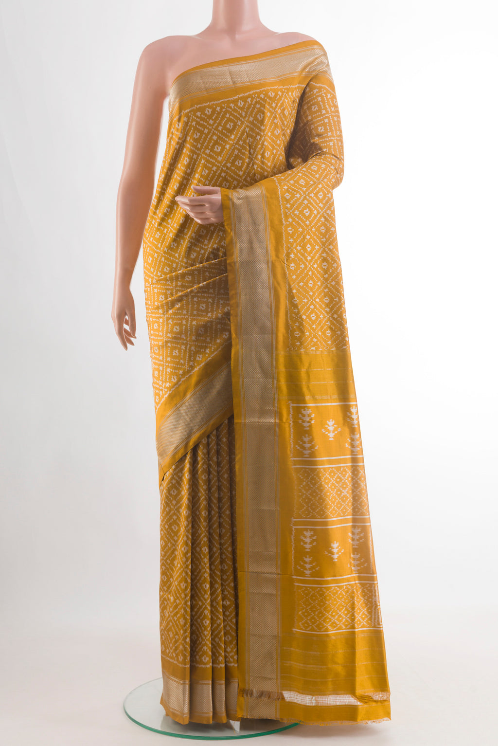 Mustard Pochampally Silk Saree with Ikat design on the body and Zari Border.  displayed on a mannequin