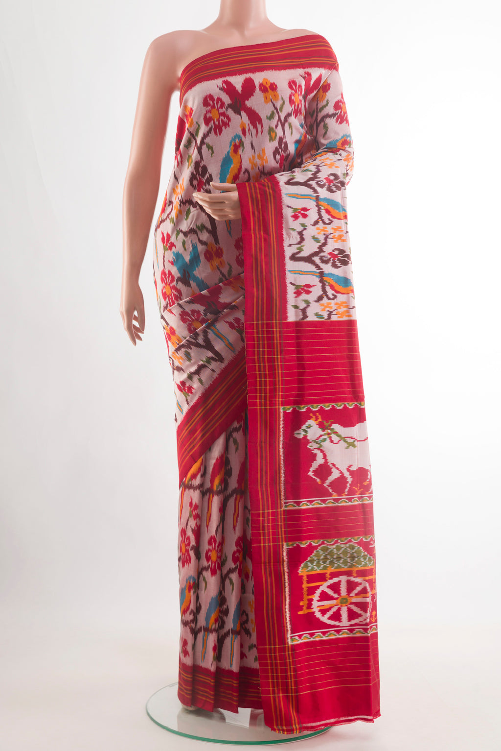 Rose Gold Pochampally Silk Saree with Pure Ikat on the body and Ikat Border.  displayed on a mannequin