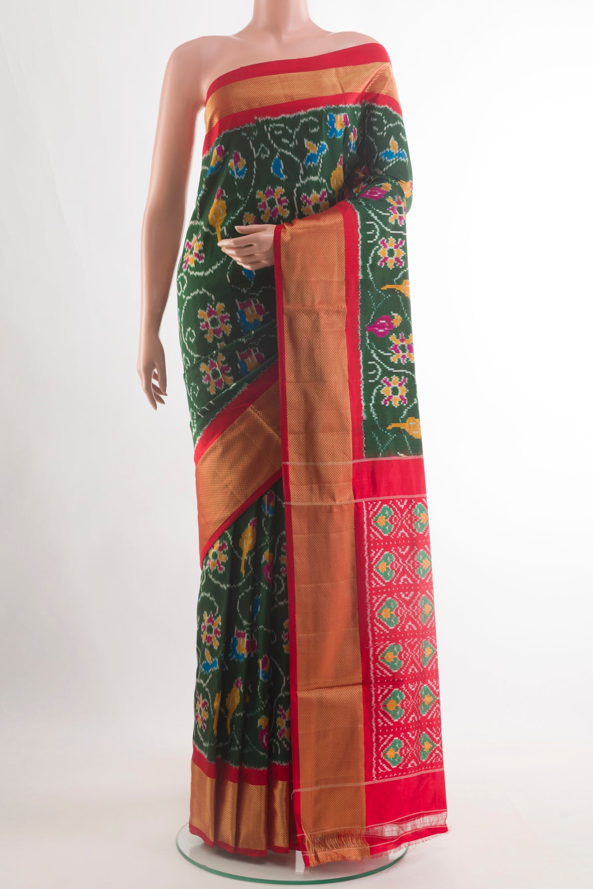 Bottle Green Pochampally Silk Saree with Pure Ikat on the body and Zari Border.  displayed on a mannequin