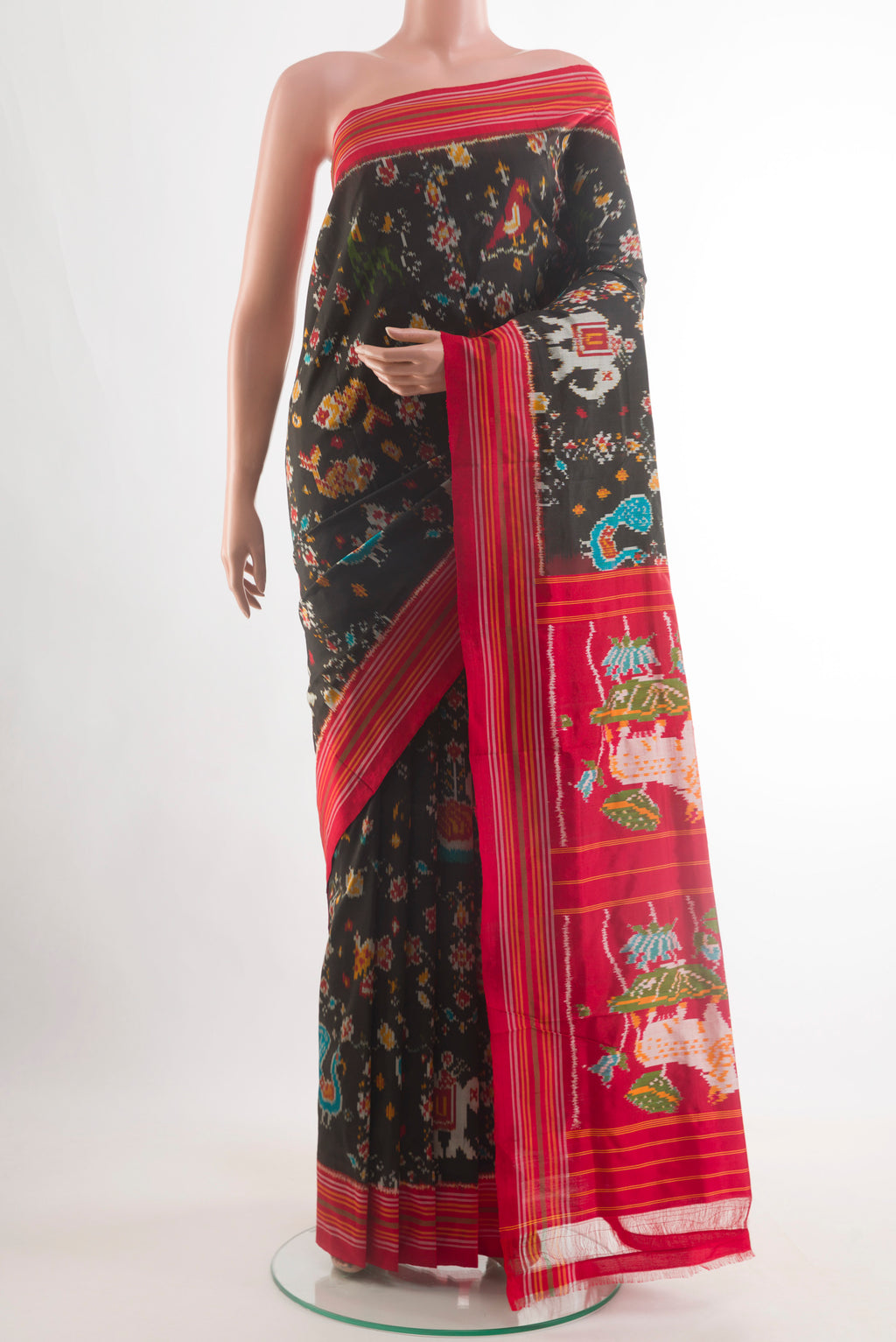 Black Pochampally Silk Saree with Pure Ikat on the body and Ikat Border.  displayed on a mannequin