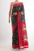 Black Pochampally Silk Saree with Pure Ikat on the body and Ikat Border.  displayed on a mannequin