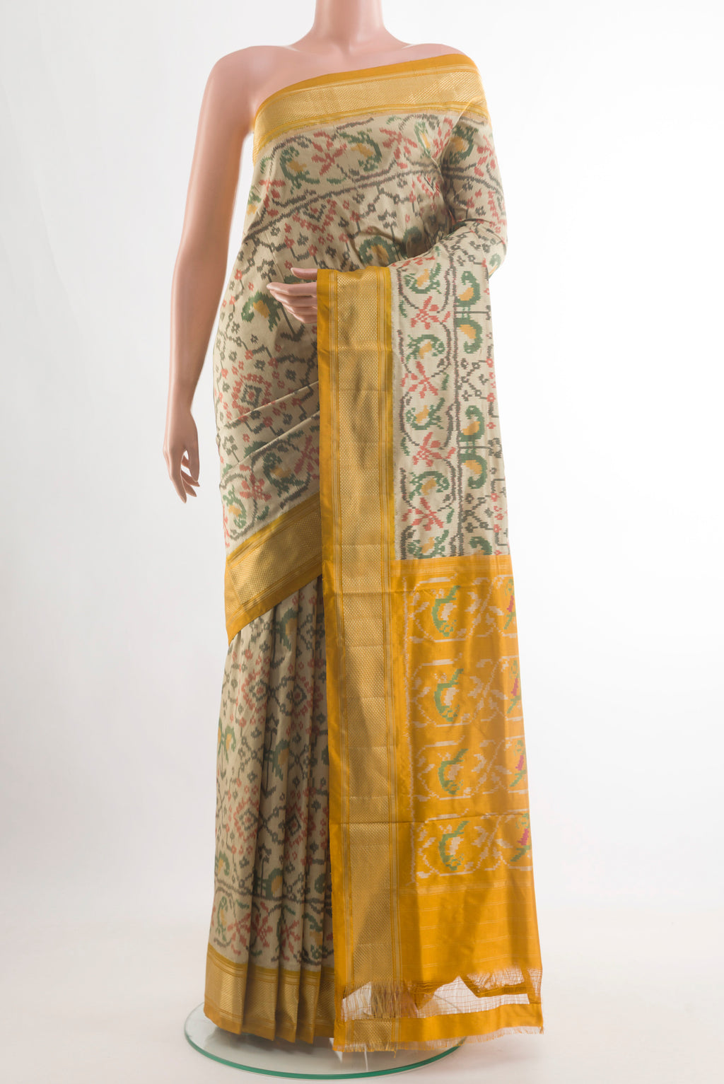 Beige Pochampally Silk Saree with Pure Ikat on the body and Zari Border.  displayed on a mannequin