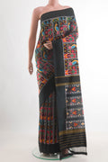 Black Pochampally Silk Saree with Pure Ikat on the body and Ikat Border.  displayed on a mannequin